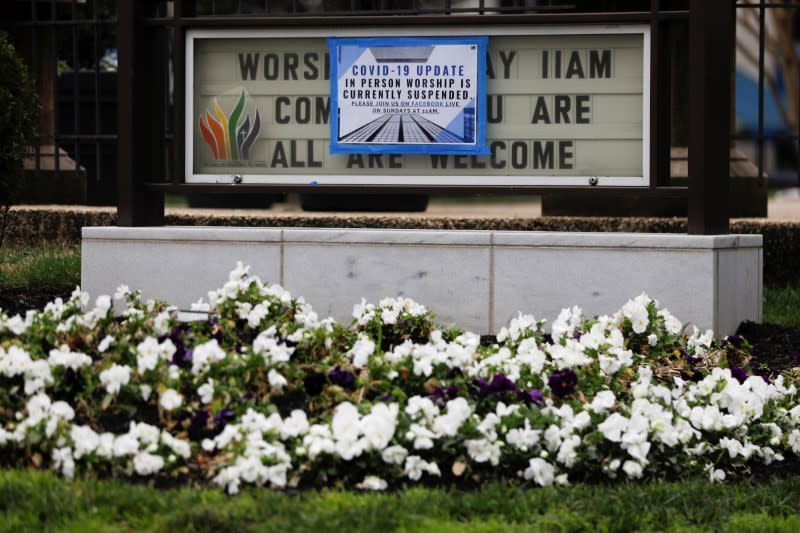 A sign displaying modified church services is posted outside Mount Vernon Place UMC in Washington