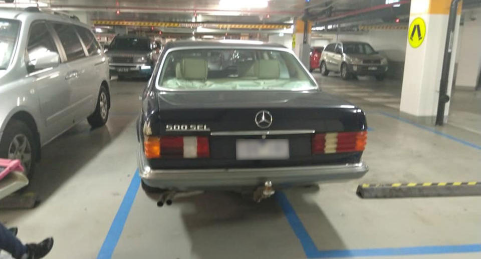 A car parked over two disability parking spots at Royal Children's Hospital in Melbourne. The vehicle is pictured here from the back.