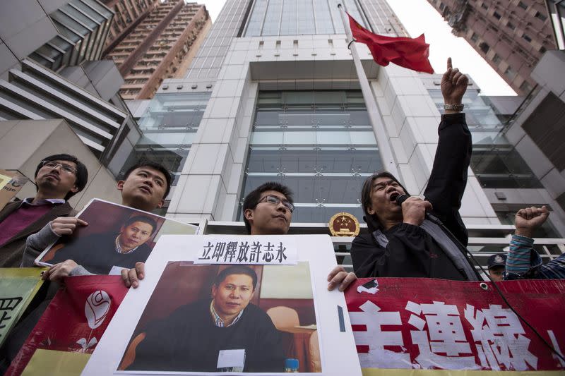 Pro-democracy lawmaker Leung burns a letter during a protest calling for the release of Chinese rights advocate Xu, in Hong Kong