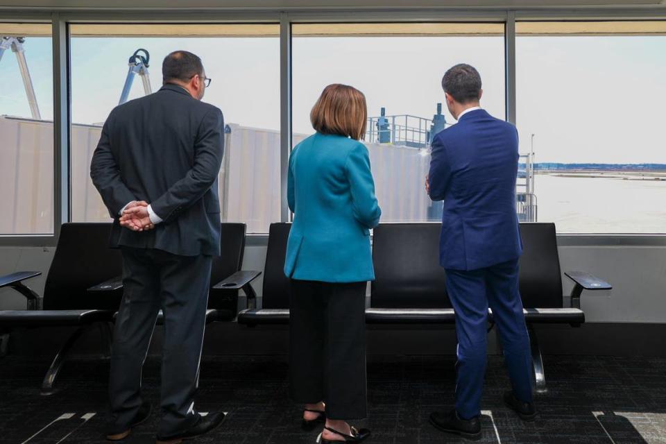 Transportation Secretary Pete Buttigieg, right, looks at a jet bridge at Charlotte-Douglas International Airport Thursday. The secretary was in North Carolina to announce almost $1 billion in federal grants for airports, including $27 million for 16 new jetways at CLT.