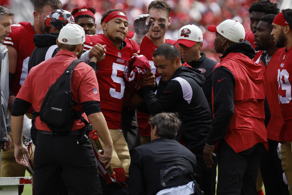 San Francisco 49ers quarterback Trey Lance (5) is helped onto a cart during the first half of an NFL football game against the Seattle Seahawks in Santa Clara, Calif., Sunday, Sept. 18, 2022. (AP Photo/Josie Lepe)