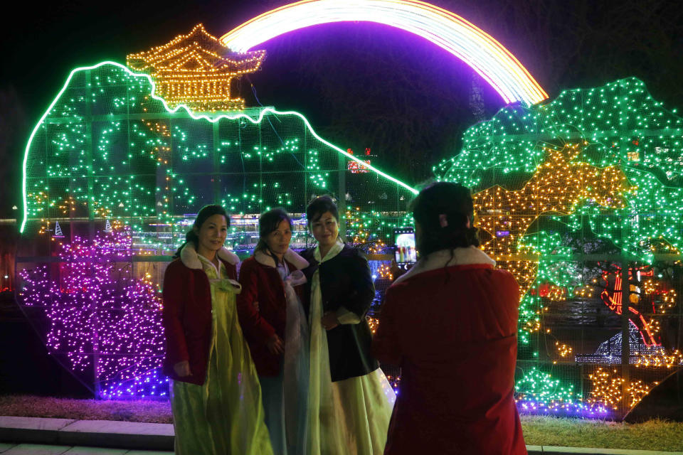 Citizens take a photo at a light festival in celebration of 110th birth anniversary of their late leader Kim Il Sung at Kim Il Sung Square in Pyongyang, North Korea Thursday, April 14, 2022. (AP Photo/Jon Chol Jin)