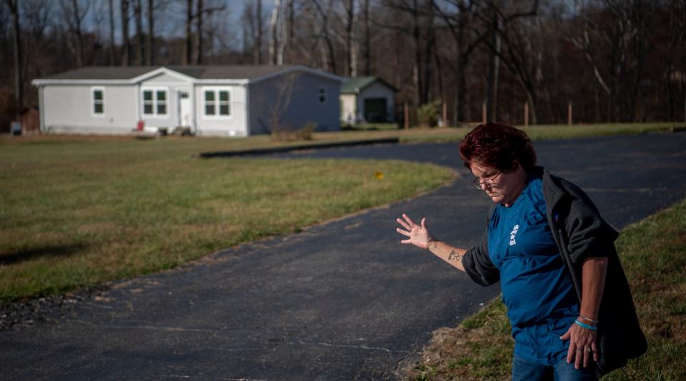 Demonstrating the force of the wind as she was blown across West Wolf Mountain Road, Felene Taylor talks about her experience on the day the tornado struck, Friday, March 30, 2023.