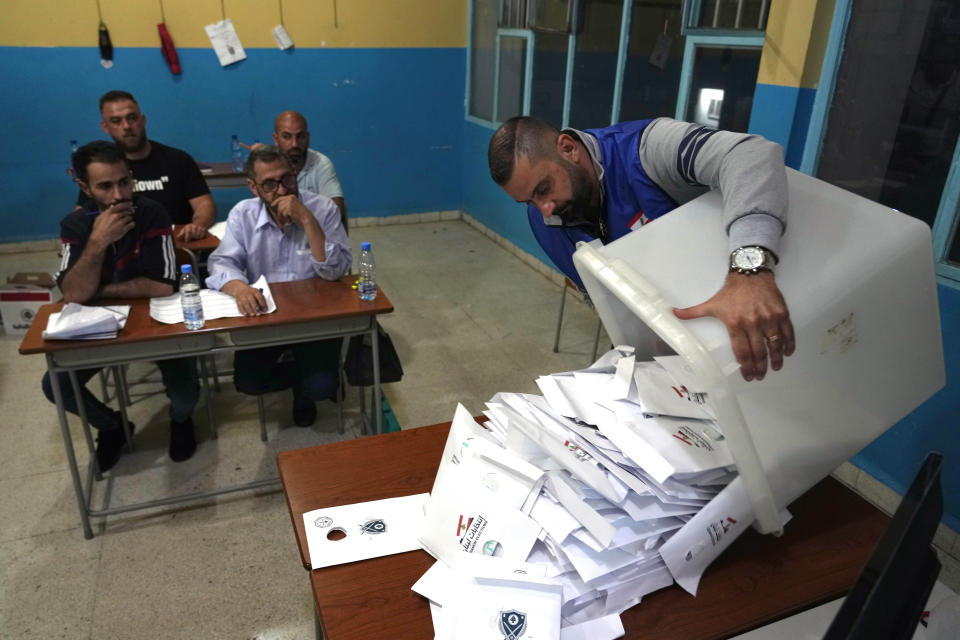 Election officials count ballots shortly after polling stations closed, in the northern city of Tripoli, Lebanon, Sunday, May 15, 2022. Lebanese voted for a new parliament Sunday against the backdrop of an economic meltdown that is transforming the country and low expectations that the election would significantly alter the political landscape. (AP Photo/Bilal Hussein)