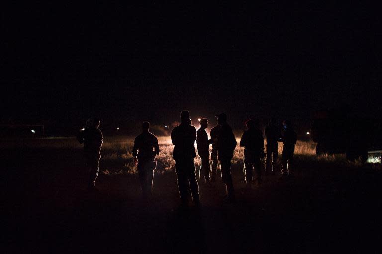 French troops taking part in operation Sangaris wait at a base camp on December 6, 2013 in Cameroon, on the border of the Central African Republic (CAR)