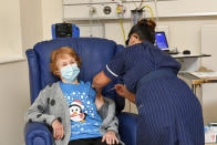 90 year old Margaret Keenan, the first patient in the UK to receive the Pfizer-BioNTech COVID-19 vaccine, administered by nurse May Parsons at University Hospital, Coventry, England, Tuesday Dec. 8, 2020. The United Kingdom, one of the countries hardest hit by the coronavirus, is beginning its vaccination campaign, a key step toward eventually ending the pandemic. (Jacob King/Pool via AP)