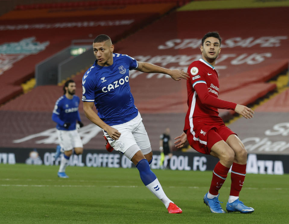 Everton's Richarlison, left, celebrates after scoring the opening goal of the game during the English Premier League soccer match between Liverpool and Everton at Anfield in Liverpool, England, Saturday, Feb. 20, 2021. (Phil Noble/ Pool via AP)