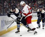 Carolina Hurricanes forward Jordan Staal, center, checks Columbus Blue Jackets forward Gustav Nyquist during the second period of an NHL hockey game in Columbus, Ohio, Saturday, Oct. 23, 2021. (AP Photo/Paul Vernon)