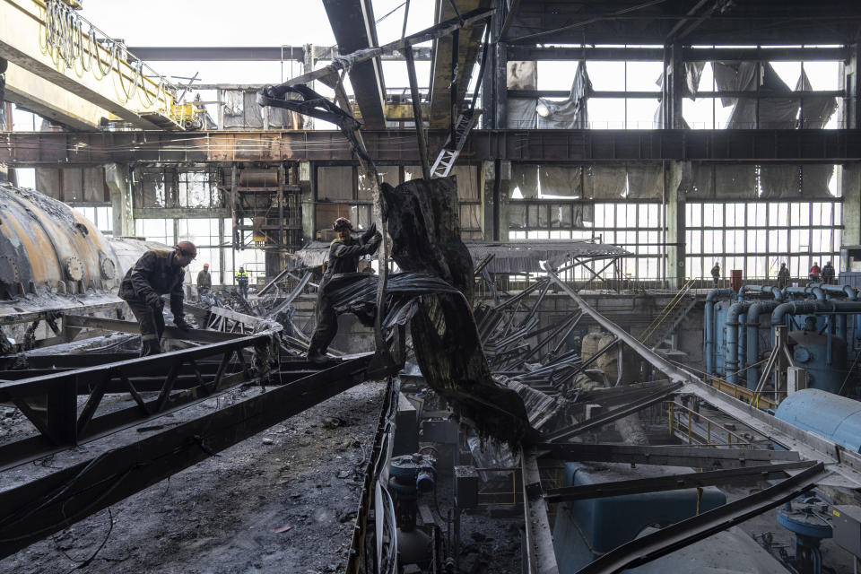 Workers clear the rubble after a Russian missile attack at DTEK's power plant in Ukraine, on Tuesday, April 2, 2024. Russia is attacking Ukraine’s energy sector with renewed intensity and alarming accuracy, signaling to Ukrainian officials that Russia is armed with better intelligence and fresh tactics in its campaign to annihilate the country’s power generation capacity. (AP Photo/Evgeniy Maloletka)