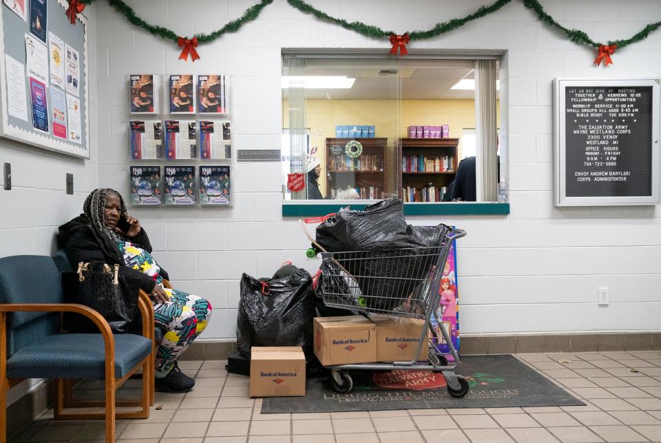 Christine Cullerton, 63, of Inkster makes a phone call to a friend in hopes of getting a ride after shopping at The Salvation Army Wayne Westland Corps Community Center on Tuesday, Dec. 19, 2023. Cullerton, who is the guardian of her 9 grandchildren, came to shop for gifts for them. "I really appreciate this," said Cullerton "I just couldn't afford a Christmas for these kids." The Salvation Army of Metro Detroit is spreading holiday cheer to families in need across southeast Michigan through the non-profit's annual toy shop drive.