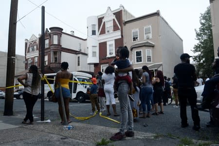 People gather on a street during an active shooter situation in Philadelphia