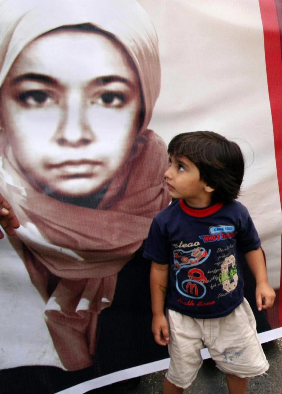 A little girl stands next to a portrait of Aafia Siddiqui during a rally called by a youth organization demanding her release from U.S. custody on Aug. 10, 2008 in Karachi, Pakistan.