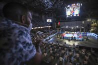 A man wearing a protective face mask looks at a fight organized by Nicaraguan two-time world box champion Rosendo "Búfalo" Álvarez in Managua, Nicaragua, April 25, 2020. With nearly all the world's sports shut down by the coronavirus pandemic, Nicaragua hosted the event with a full card of boxing matches before a live audience, organized by former world boxing champion Alvarez, who like the Central American nation's government, waved aside the threat of COVID-19. (AP Photo/Alfredo Zuniga)