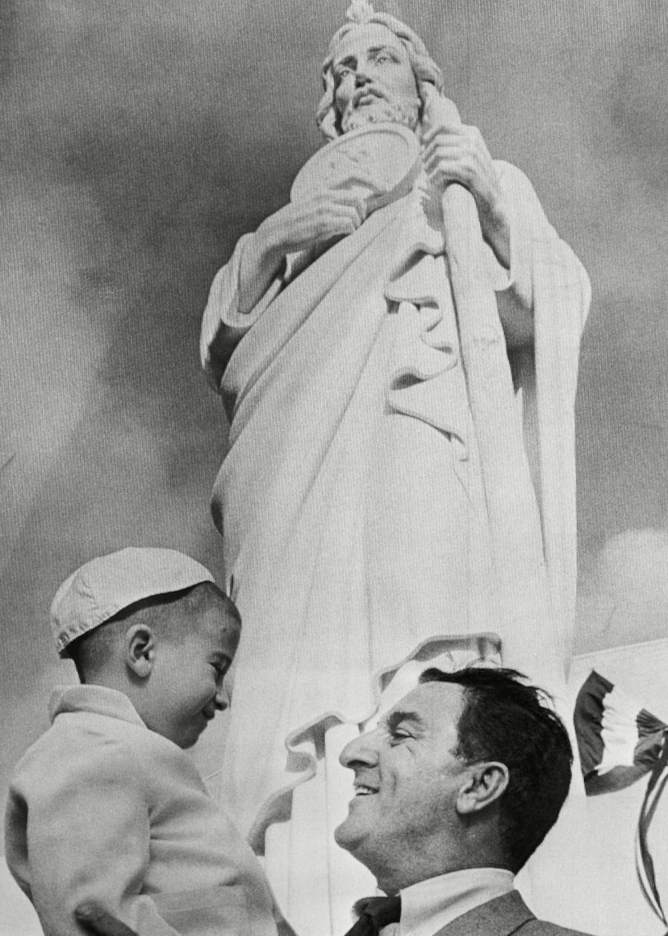 Comedian Danny Thomas happily greeted an unidentified fan after unveiling the statue of St. Jude at dedication ceremonies for the new five million dollar hospital on in Memphis. 25 years earlier Thomas prayed to St. Jude, the Patron Saint of hopeless causes, asking success and promised a shrine in return. The hospital will specialize in research in children's diseasesDanny Thomas, Memphis, USA