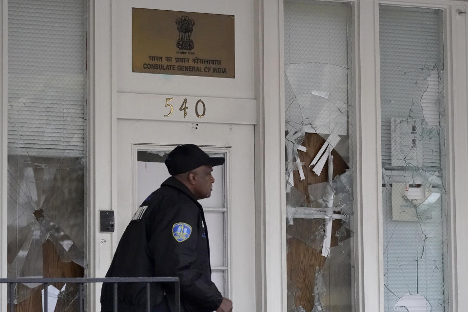 A security guard walks in front of the entrance to the Consulate General of India in San Francisco, Monday, March 20, 2023. San Francisco police had erected barriers and parked a vehicle nearby as people protested outside the Consulate General of India to protest the capture of Amritpal Singh. (AP Photo/Jeff Chiu)