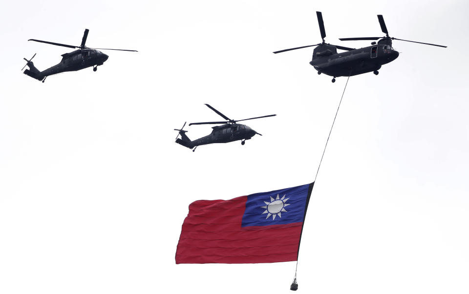 Helicopters fly over with Taiwan National flag during an inauguration celebration of Taiwan's President Lai Ching-te in Taipei, Taiwan, Monday, May 20, 2024. (AP Photo/Chiang Ying-ying)