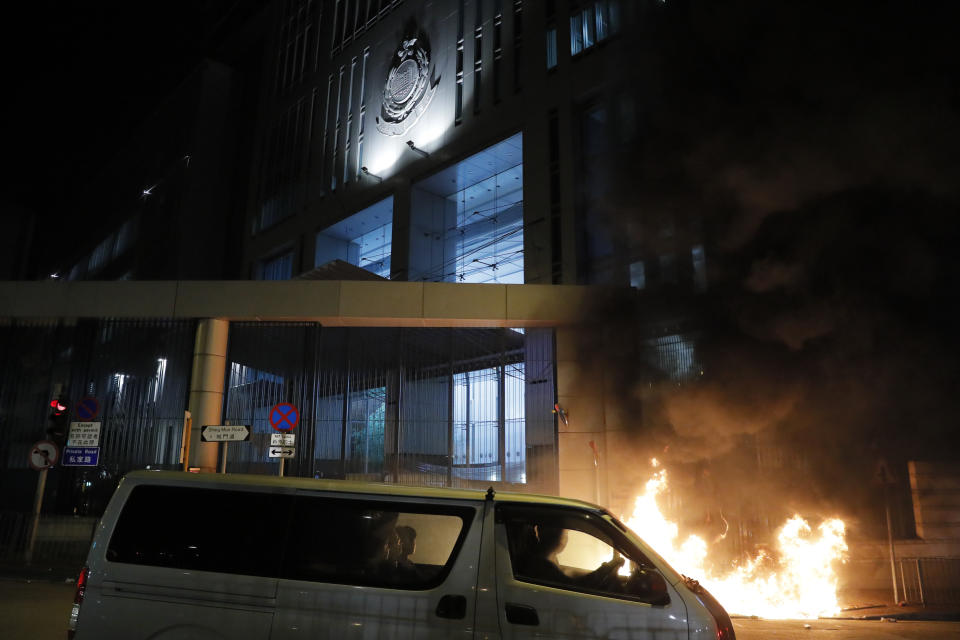 A fire burns outside a police station in Hong Kong on Wednesday, Oct. 2, 2019. Protests continue a day after police shot a teenage demonstrator at close range during widespread anti-government demonstrations on China's National Day and marked a fearsome escalation in Hong Kong's protest violence. (AP Photo/Kin Cheung)