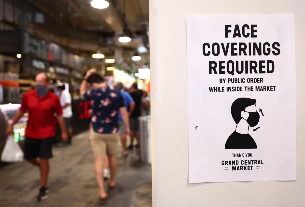 <span class="caption">Signs like this may become more common as localities consider CDC guidelines.</span> <span class="attribution"><a class="link " href="https://www.gettyimages.com/detail/news-photo/sign-is-posted-about-required-face-coverings-in-grand-news-photo/1329567933" rel="nofollow noopener" target="_blank" data-ylk="slk:Mario Tama/Getty Images;elm:context_link;itc:0;sec:content-canvas">Mario Tama/Getty Images</a></span>