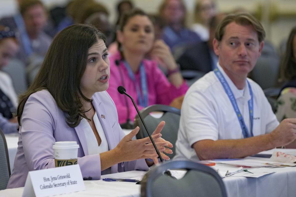 Colorado Secretary of State Jena Griswold talks to her colleagues on July 8, 2022, at a national conference about threats that had been made against her. The previous month, a man pleaded guilty to making death threats against Griswold. <a href="https://newsroom.ap.org/detail/ElectionOfficialsThreats/14aecbdb2efd4d67a0c4774805fd0489/photo?Query=threats%20election%20officials&mediaType=photo&sortBy=arrivaldatetime:desc&dateRange=Anytime&totalCount=154&currentItemNo=31" rel="nofollow noopener" target="_blank" data-ylk="slk:Matthew Hinton/AP Photos;elm:context_link;itc:0;sec:content-canvas" class="link ">Matthew Hinton/AP Photos</a>