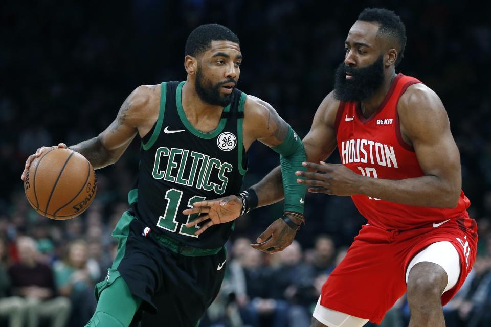 Boston Celtics' Kyrie Irving (11) drives past Houston Rockets' James Harden during the first half of an NBA basketball game in Boston, Sunday, March 3, 2019. (AP Photo/Michael Dwyer)