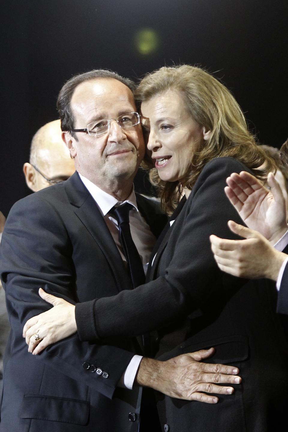 FILE - In this Sunday, May 6, 2012 file photo French president-elect Francois Hollande embraces his companion Valerie Trierweiler after greeting crowds gathered to celebrate his election victory in Bastille Square in Paris, France. A French news agency has reported that President Francois Hollande has ended his relationship with his companion of seven years Valerie Trierweiler. (AP Photo/Laurent Cipriani, File)