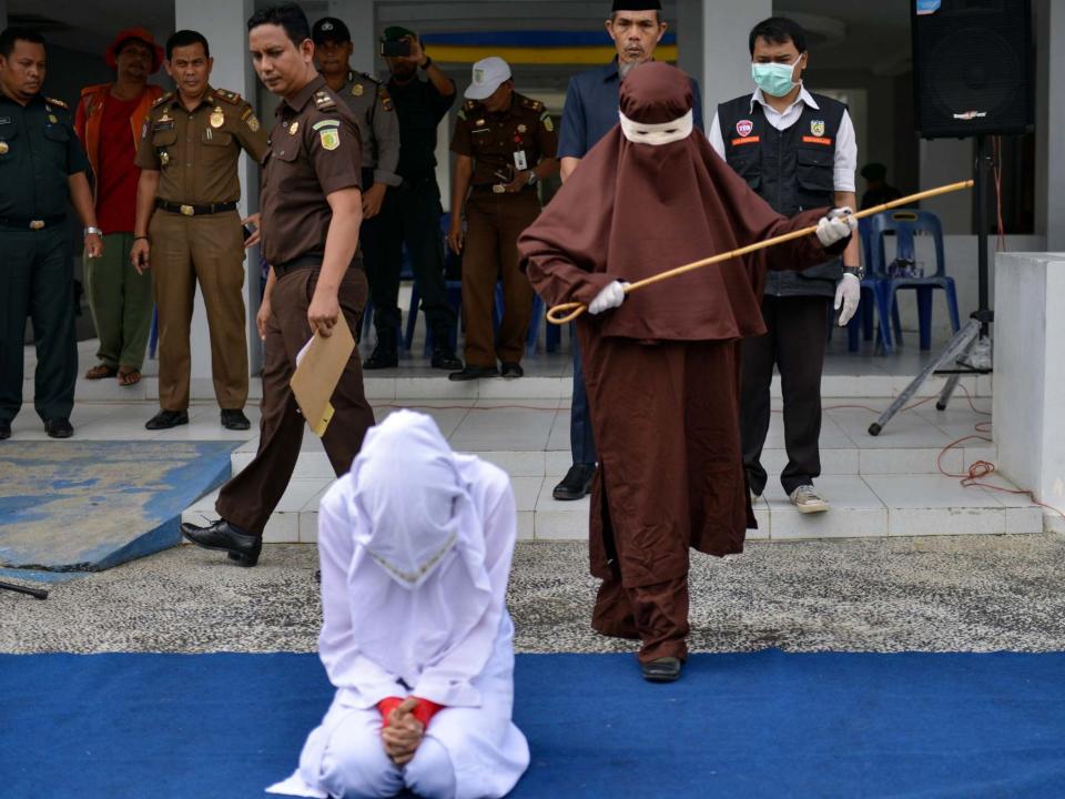 Indonesia's first female flogger prepares to whip a woman in public: CHAIDEER MAHYUDDIN/AFP via Getty Images