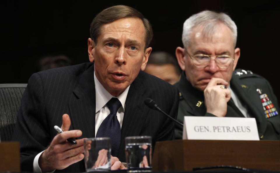 CIA Director David Petraeus (L) speaks to members of a Senate (Select) Intelligence hearing on "World Wide Threats" on Capitol Hill in Washington January 31, 2012. At right is Lt. Gen. Ronald Burgess. REUTERS/Kevin Lamarque