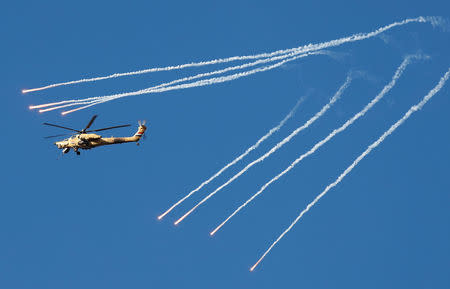 An Iraqi Airforce helicopter deploys flares during a battle with Islamic State fighters at an outskirts of Mosul, Iraq. REUTERS/Goran Tomasevic