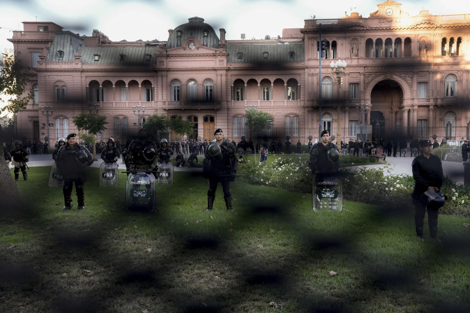 Police guard the Casa Rosada presidential palace during a march by demonstrators demanding more funding for public universities and to protest against austerity measures proposed by President Javier Milei, in Buenos Aires, Argentina, Tuesday, April 23, 2024. (AP Photo/Rodrigo Abd)