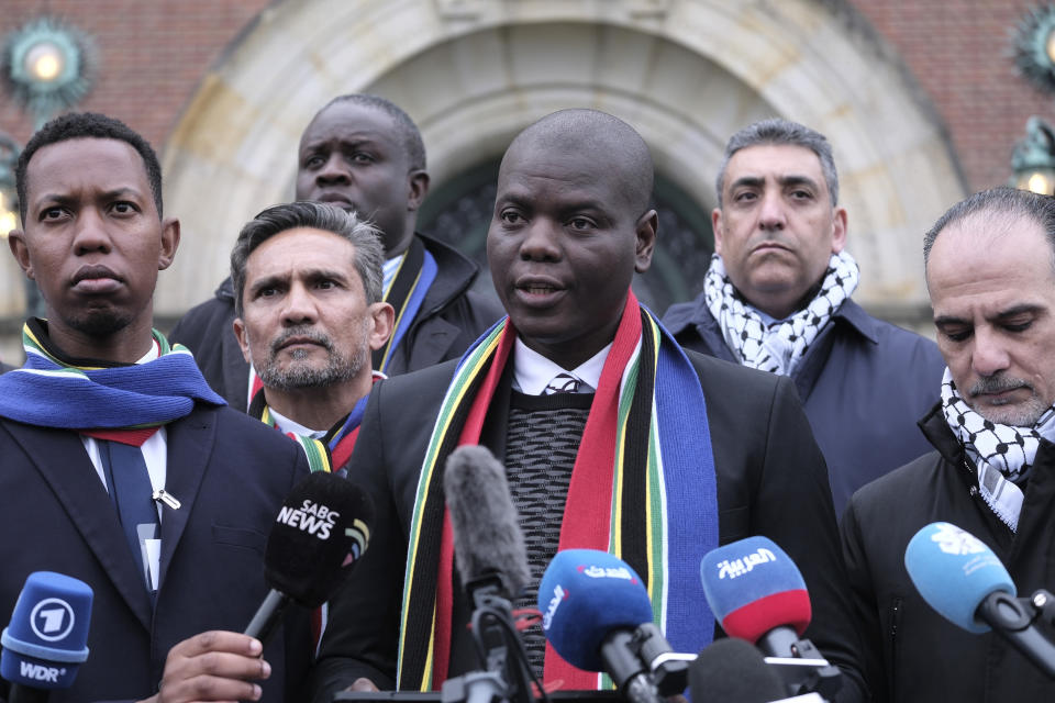 FILE - South Africa's Minister of Justice and Correctional Services Ronald Lamola, center, and Palestinian assistant Minister of Multilateral Affairs Ammar Hijazi, right, address the media outside the International Court of Justice in The Hague, Netherlands, Thursday, Jan. 11, 2024. Fighting “human animals.” “No uninvolved civilians in Gaza.” Making Gaza a “slaughterhouse.” These are just some of the comments made by Israeli leaders, soldiers and entertainers about Palestinians in Gaza since Hamas’ attack on Oct. 7 sparked a war with Israel. Such inflammatory rhetoric is a key component of South Africa’s case accusing Israel of genocide at the U.N. world court, a charge Israel denies. South Africa says the language is proof of Israel’s intent to commit genocide. (AP Photo/Patrick Post, File)