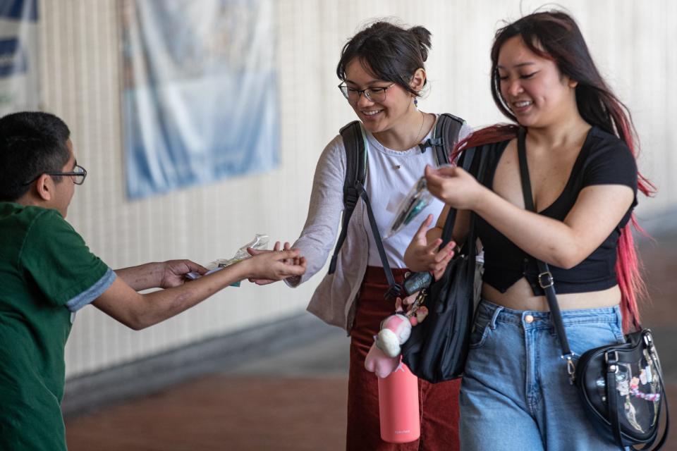 Mary Grett Transition Center and TIDES program student Daniel Alvarez, left, hands "kindness bracelets" to university students Kayla Gaspar, center, and Mia Marcelo to promote the Best Buddies program at Texas A&M University-Corpus Christi on Feb. 22, 2023. TIDES, which stands for Teaching Independence, Empowerment and Determination Skills, is a university program that aims to help young adults with disabilities develop independent living skills.