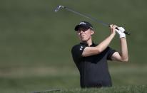 England's Matthew Fitzpatrick follows his ball on the first hole during the final round of the Abu Dhabi Championship golf tournament in Abu Dhabi, United Arab Emirates, Sunday, Jan. 19, 2020. (AP Photo/Kamran Jebreili)