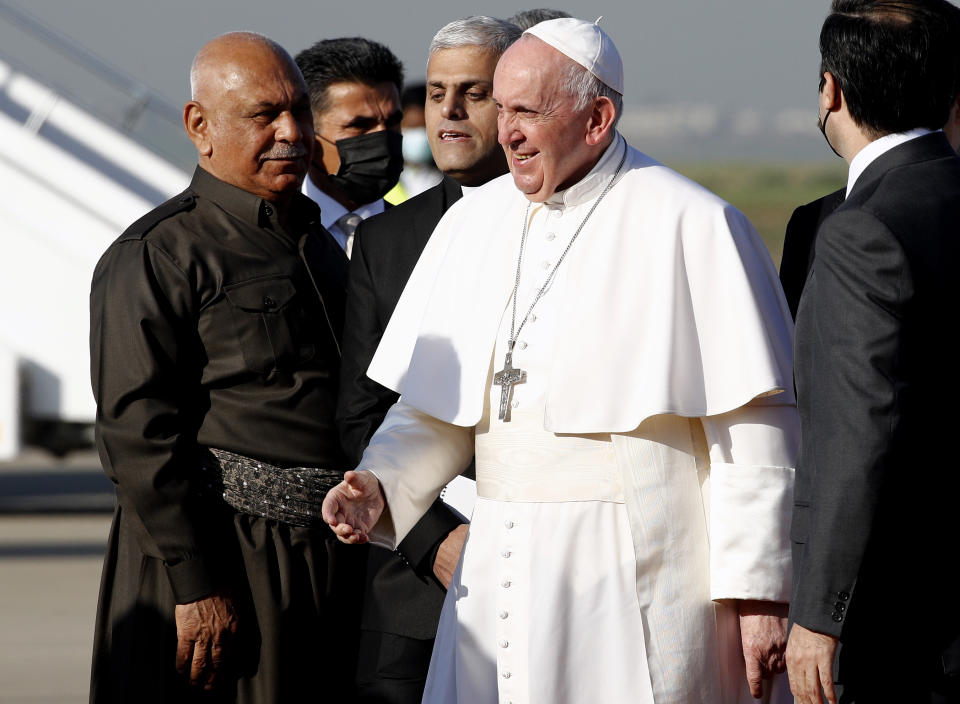 Pope Francis arrives at Irbil airport, Iraq, Sunday, March 7, 2021. Pope Francis arrived in northern Iraq on Sunday, where he planned to pray in the ruins of churches damaged or destroyed by Islamic State extremists and celebrate an open-air Mass on the last day of the first-ever papal visit to the country. (AP Photo/Hadi Mizban)