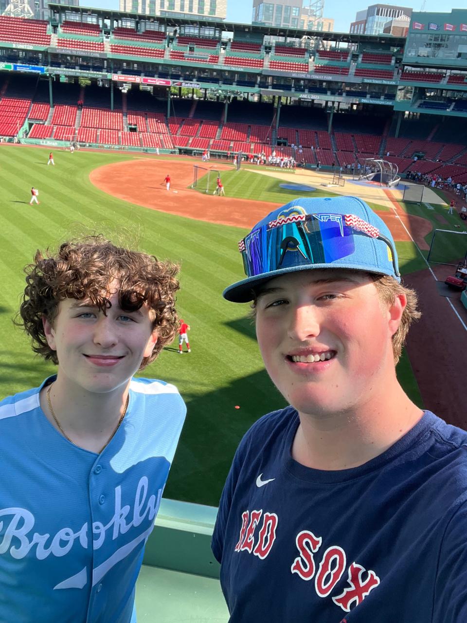 Aaron Buckley and his younger brother, Bryton, left, enjoyed a game Thursday night from atop the Green Monster at Fenway Park