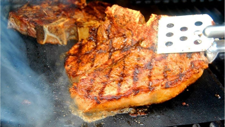 A grill mat is perfect for sticky foods--or things that might fall through the grates.