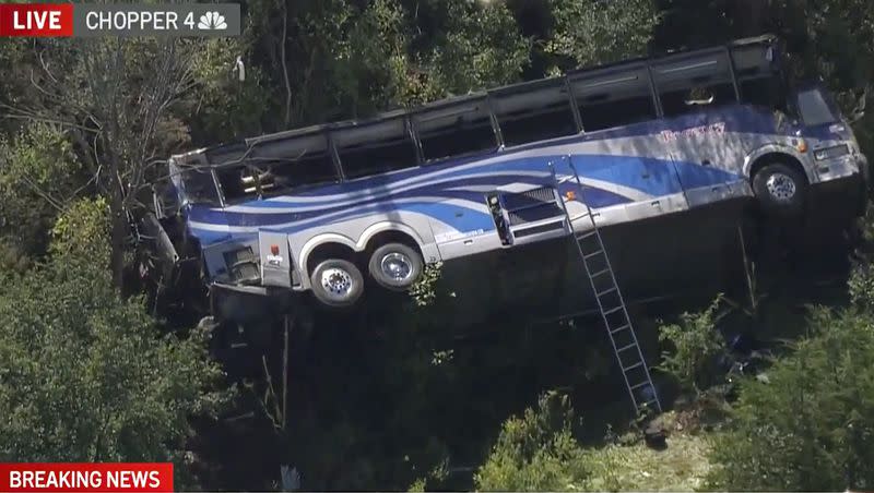 A bus lies on its side where it crashed along Interstate 84, in Wawayanda, N.Y., on Thursday, Sept. 21, 2023. The charter bus carrying high school students to a band camp hurtled off the New York highway and down an embankment, killing one person and hurting dozens of others, officials said.