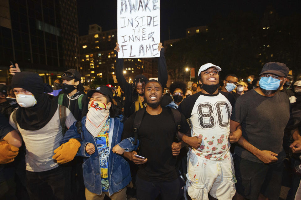 Activists march to the Brooklyn Bridge on Sunday, May 31, 2020, in New York. Demonstrators took to the streets of New York City to protest the death of George Floyd, who died May 25 after he was pinned at the neck by a Minneapolis police officer. (AP Photo/Kevin Hagen).