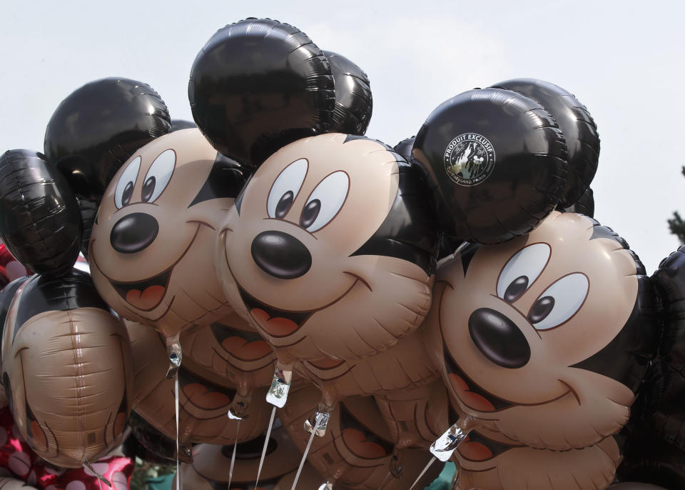 FILE - Mickey Mouse balloons appear at Disneyland Paris, May 12, 2015, in Chessy, France, east of Paris. The earliest version of Disney's most famous character, Mickey Mouse, and arguably the most iconic character in American pop culture, will become public domain on Jan. 1, 2024. (AP Photo/Michel Euler, File)