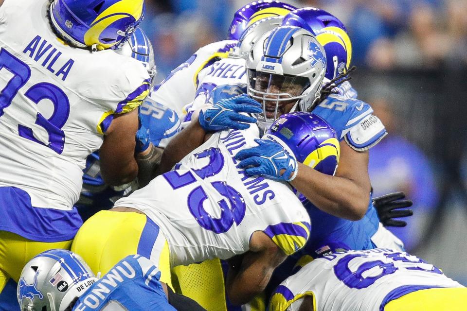Detroit Lions defensive tackle Alim McNeill (54) tackles L.A. Rams running back Kyren Williams (23) during the second half of the NFL wild-card playoff game at Ford Field in Detroit on Sunday, Jan, 14, 2024.