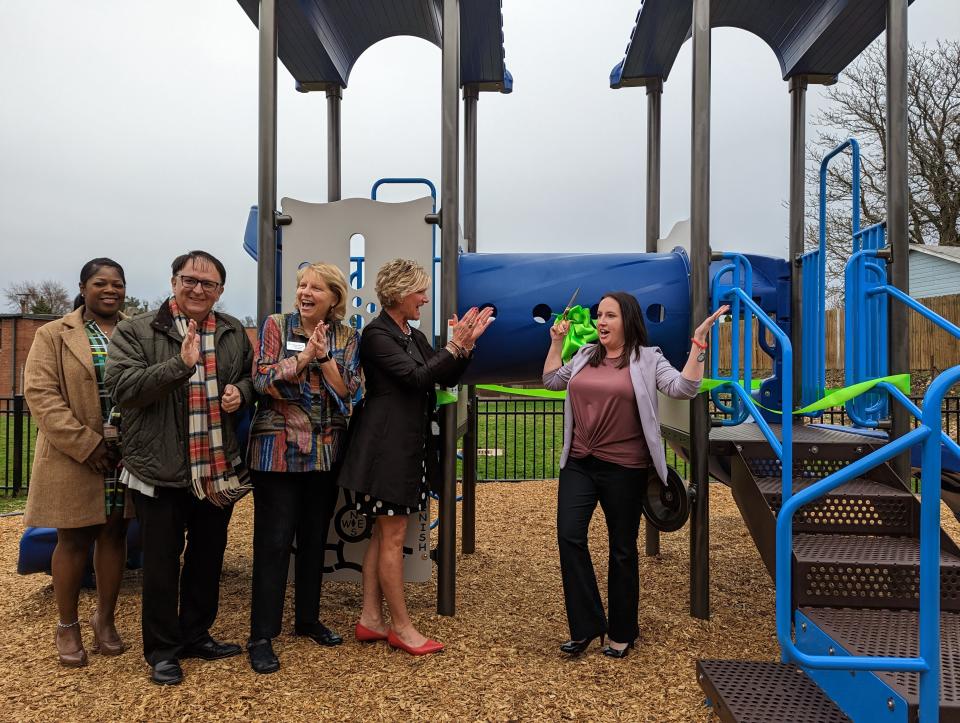 JRC CEO Julie Abiecunas (right) celebrates the dedication of new playground equipment at the JRC Learning Center in Canton Township. Looking on, left to right, are Gia Bell, JRC chief program officer; Joe French, CEO of Child & Adolescent Behavioral Health; Nancy Cochran, JRC board vice president; and Sandy K. Upperman, a community president with Huntington Bank, which donated the equipment.