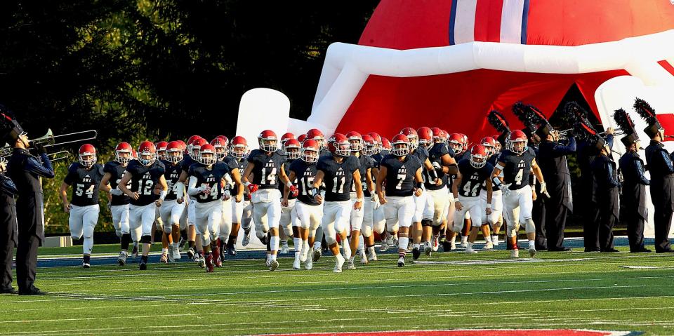 Bedford North Lawrence makes its entrance onto the field prior to the start of their Hoosier Hills Conference matchup with New Albany.