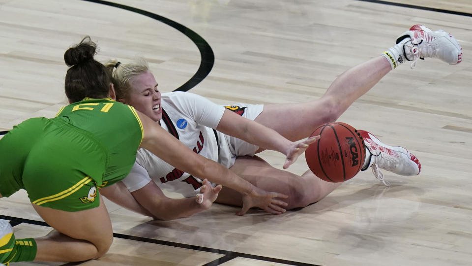 Oregon forward Erin Boley (21) and Louisville guard Hailey Van Lith, right, scramble for a loose ball during the first half of a college basketball game in the Sweet Sixteen round of the women's NCAA tournament at the Alamodome in San Antonio, Sunday, March 28, 2021. (AP Photo/Eric Gay)