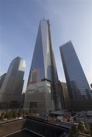 World Trade Center 1 looms over the north reflecting pool at the 9/11 Memorial during ceremonies marking the 12th anniversary of the 9/11 attacks on the World Trade Center in New York September 11, 2013. REUTERS/Allan Tannenbaum/Pool