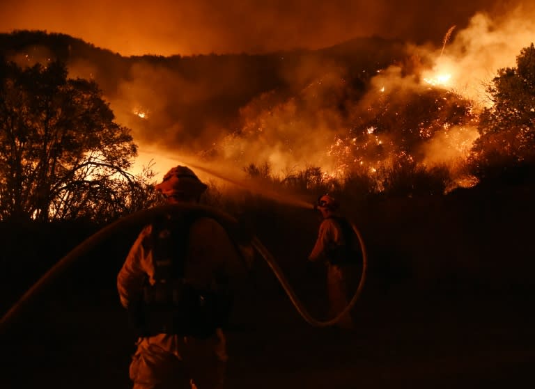 Firefighters battle a blaze dubbed the "Sand Fire" as it moves towards Fair Oaks Canyon housing estate in Santa Clarita, California