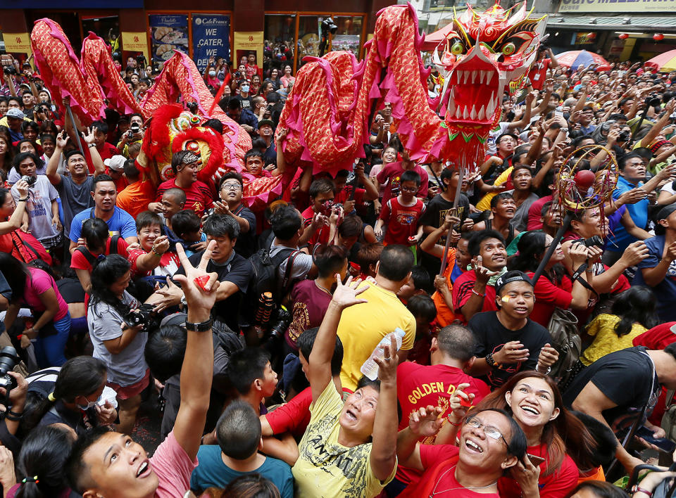 People try to catch red envelopes containing cash known as 