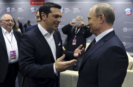 Greek Prime Minister Alexis Tsipras (L) speaks with Russian President Vladimir Putin during a session of the St. Petersburg International Economic Forum 2015 (SPIEF 2015) in St. Petersburg, Russia, June 19, 2015. REUTERS/Mikhail Klimentyev/RIA Novosti/Kremlin