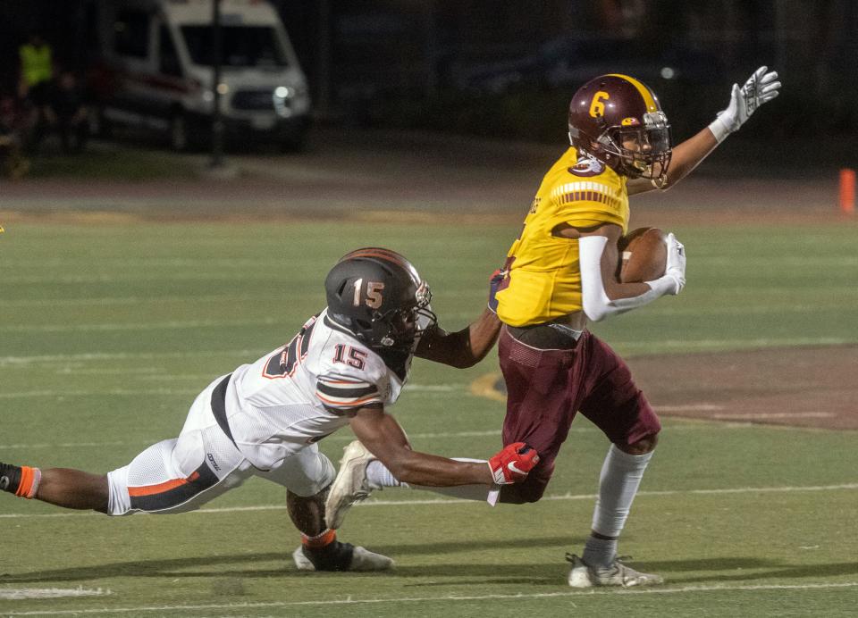 Edison's FLangon Horace (6), right, is tackled by Central's Imari Conley (15) during a varsity football game at Edison's Magnasco Stadium in Stockton on Friday, August 19, 2022. 