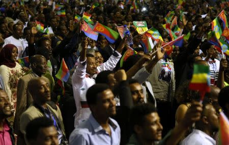 Residents wave the Ethiopian and Eritrean national flags as they dance during a concert at the Millennium Hall in Addis Ababa, Ethiopia July 15, 2018. REUTERS/Tiksa Negeri