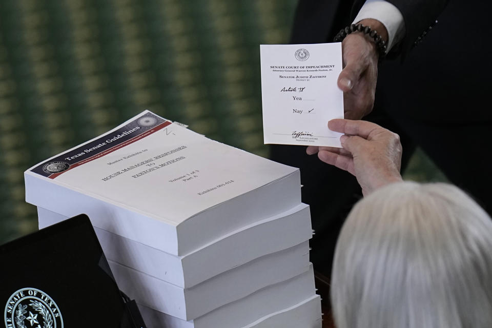 Texas state Sen. Judith Zaffirini, right, acting as a juror votes on the articles of impeachment against suspended Texas Attorney General Ken Paxton in the Senate Chamber at the Texas Capitol, Saturday, Sept. 16, 2023, in Austin, Texas. (AP Photo/Eric Gay)