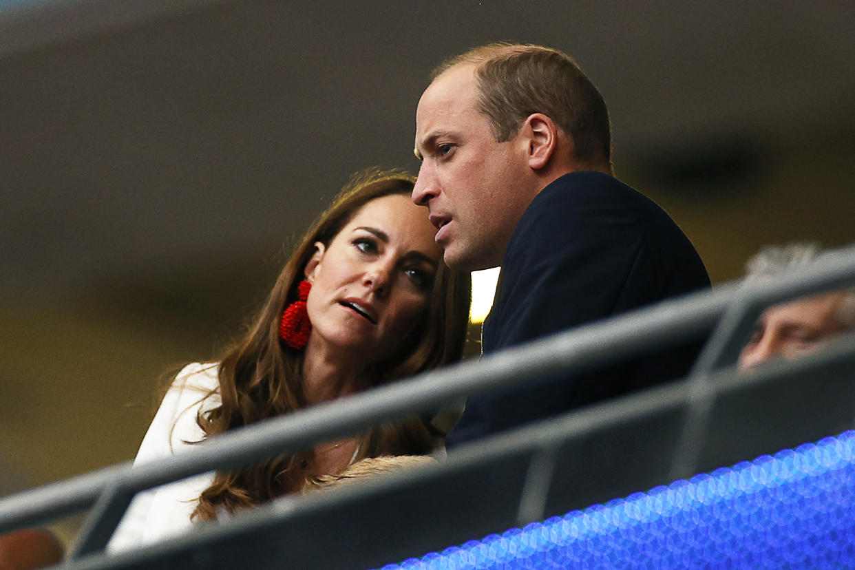 Prince William (R), Duke of Cambridge, listens to Catherine, Duchess of Cambridge, ahead of the UEFA EURO 2020 final football match between Italy and England at the Wembley Stadium in London on July 11, 2021. (Photo by JOHN SIBLEY / POOL / AFP) (Photo by JOHN SIBLEY/POOL/AFP via Getty Images)